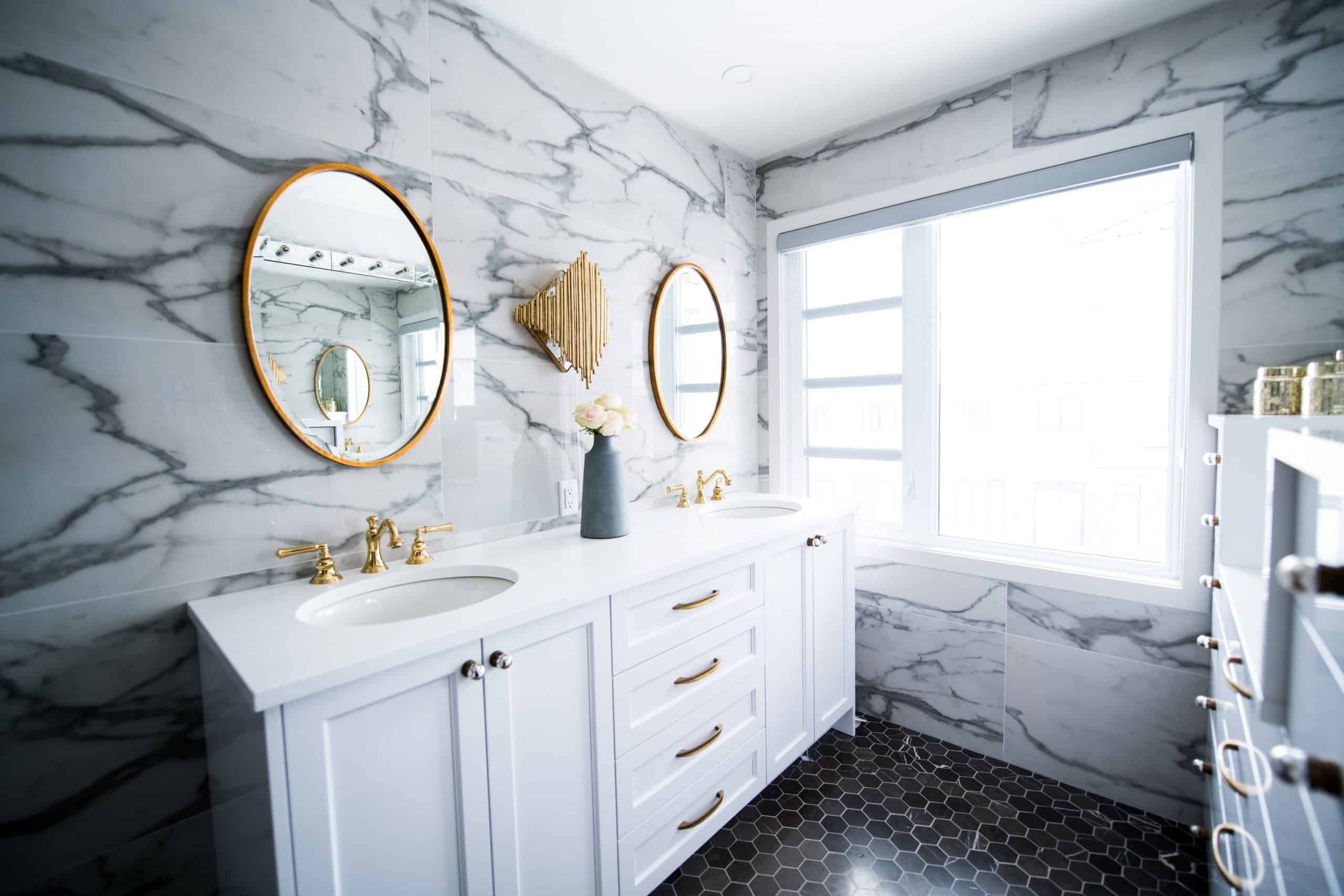 white bathroom cabinets with marble bathroom wall