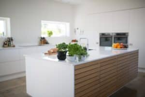 white kitchen island with wood panels