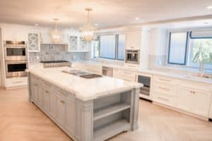 white marble kitchen island with grey base cabinets