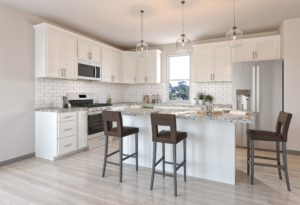 kitchen with white cabinets and light brown flooring